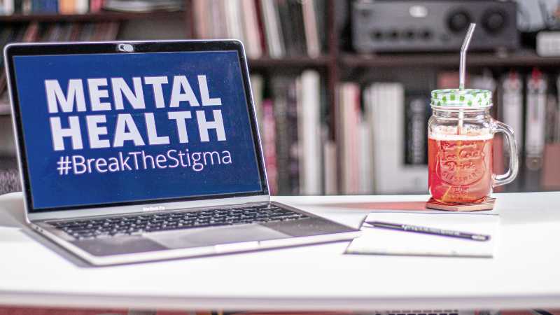 Laptop displaying the words “Mental Health” in screenfilling capital letters