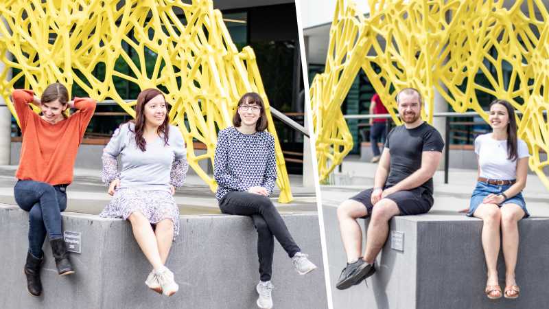 A picture composed of two photos: to the left three PhD students sitting on a concrete block in front of a yellow metal sculpture, to the right two PhD students in the same place